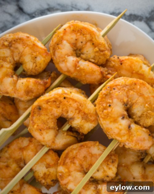 Zesty Lemon Garlic Baked Shrimp 4 Garlic roasted shrimp skewers arranged on a serving platter