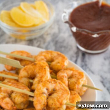 Zesty Lemon Garlic Baked Shrimp 5 A plate of perfectly baked garlic shrimp with lemon wedges