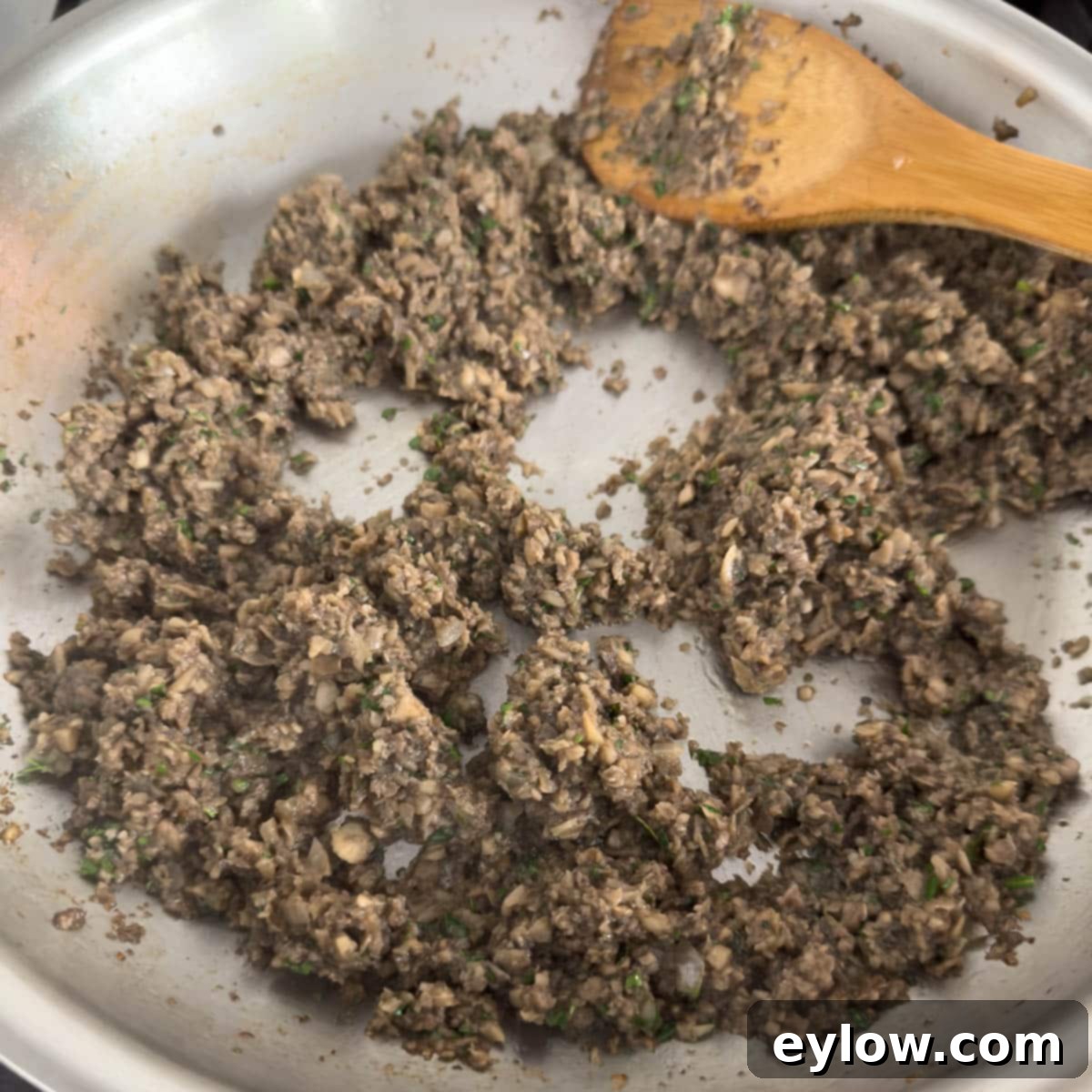 Mushrooms almost finished cooking, getting drier in the pan.