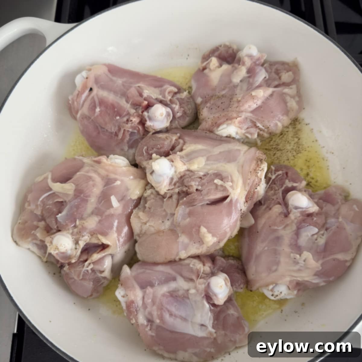 Effortless One Pan Italian Chicken Thighs 5 Searing chicken thighs in a wide shallow pan, skin side down, in olive oil.