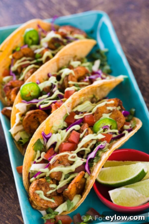 Spicy grilled shrimp tacos on a plate.