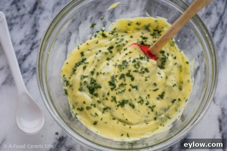 The finished mayo, stirring in fresh chopped herbs.