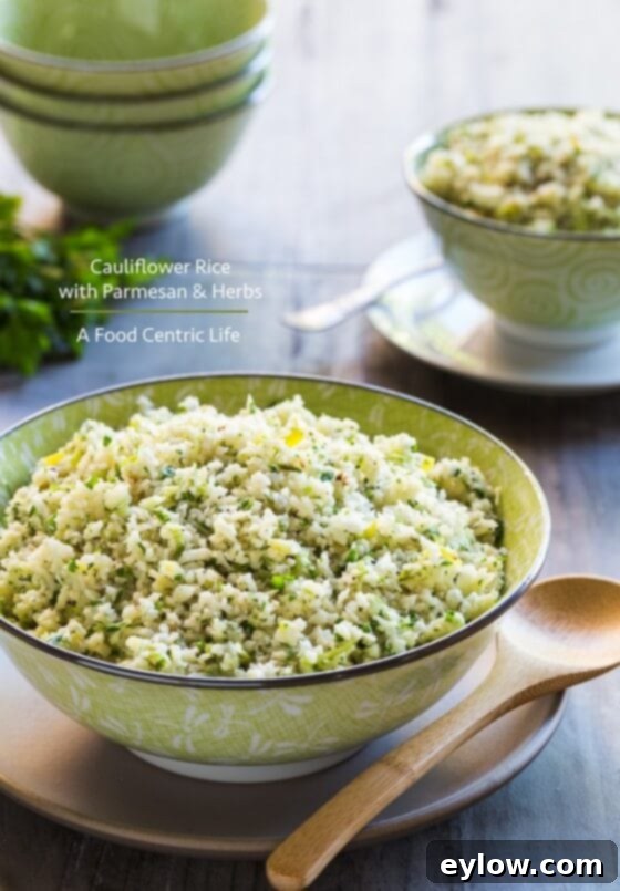 Creamy Cheesy Cauliflower Rice 2 Cauliflower rice with herbs in a green bowl.
