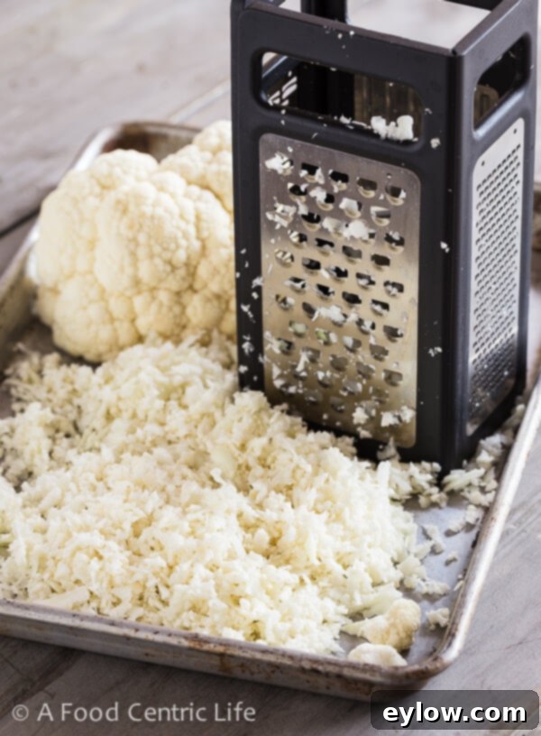 Creamy Cheesy Cauliflower Rice 3 Grating cauliflower into rice with box hand grater.