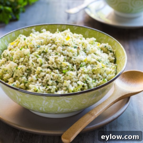 Creamy Cheesy Cauliflower Rice 5 Cauliflower rice with parmesan and herbs in a serving bowl.