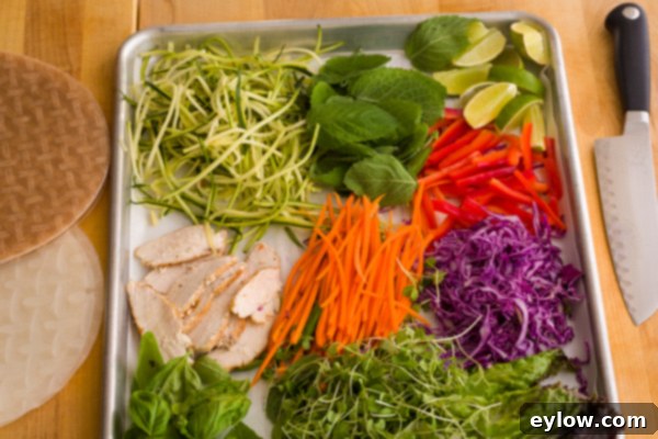 Vibrant Vegetable Spring Rolls with Creamy Peanut Sauce 3 A selection of fresh, colorful vegetables laid out for making spring rolls.