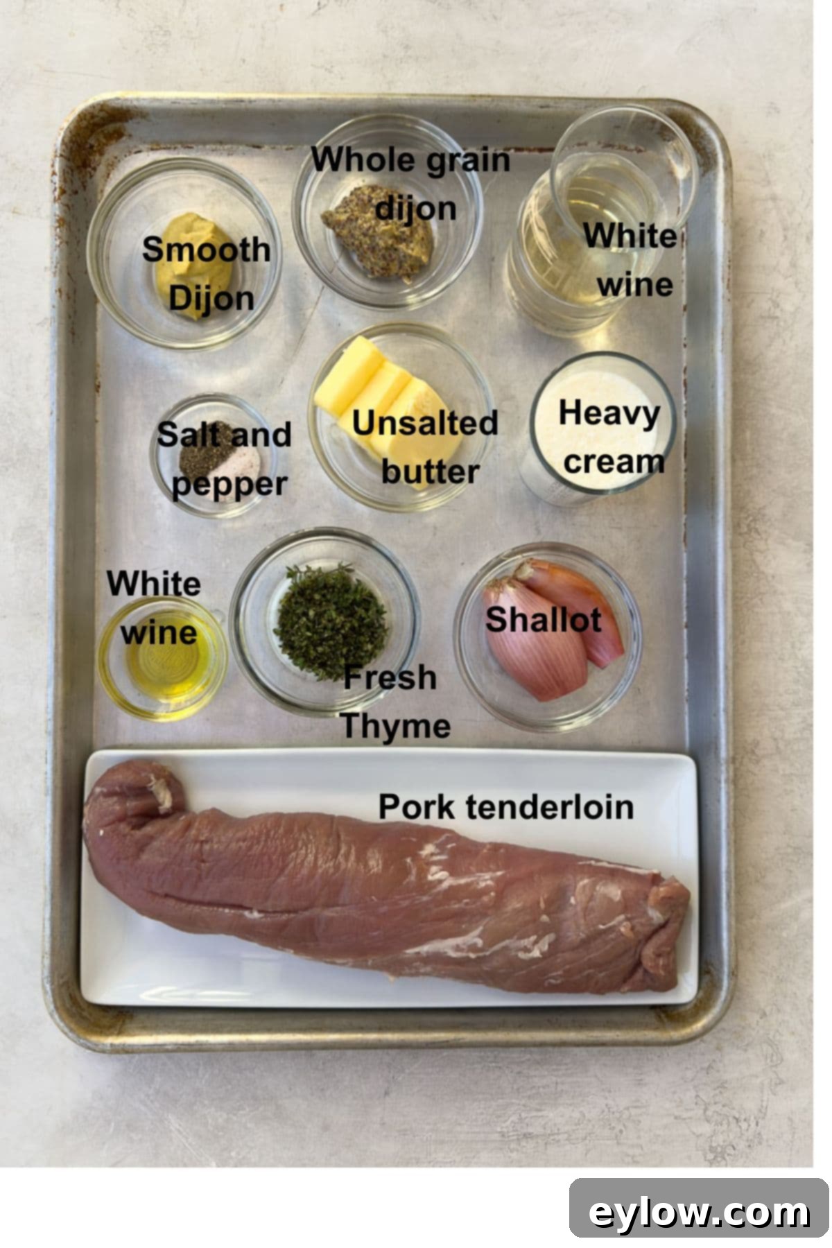 Ingredients for pork tenderloin with mustard sauce on a sheet tray.