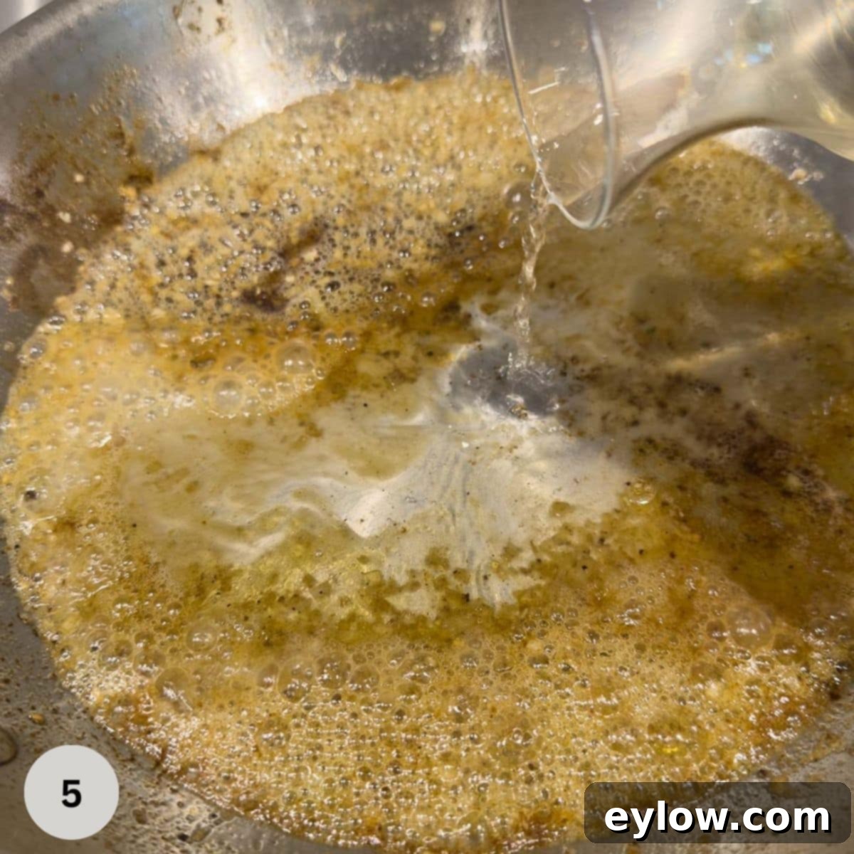 Deglazing a pan after searing pork to make a pan sauce with mustard cream.