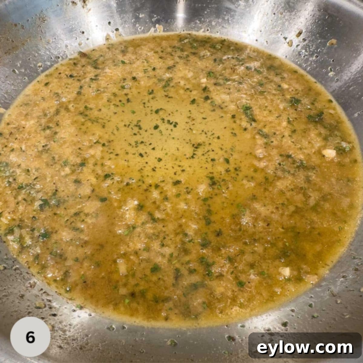 A tasty pan sauce being created in a stainless steel fry pan for pork tenderloin.