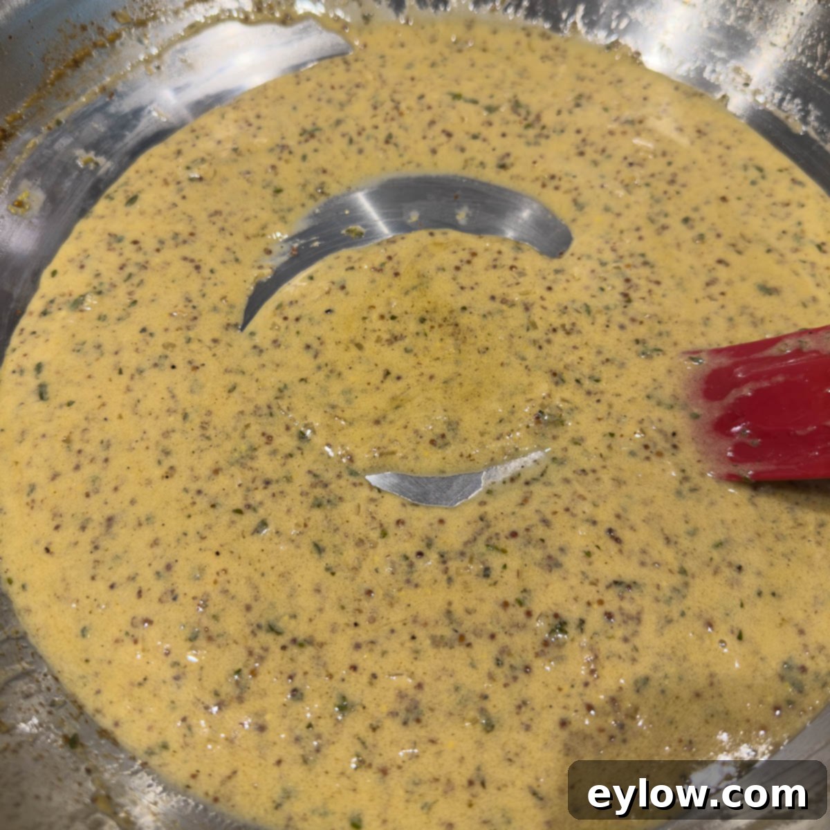 Thickened mustard cream sauce finishing in the pan, ready to serve. 