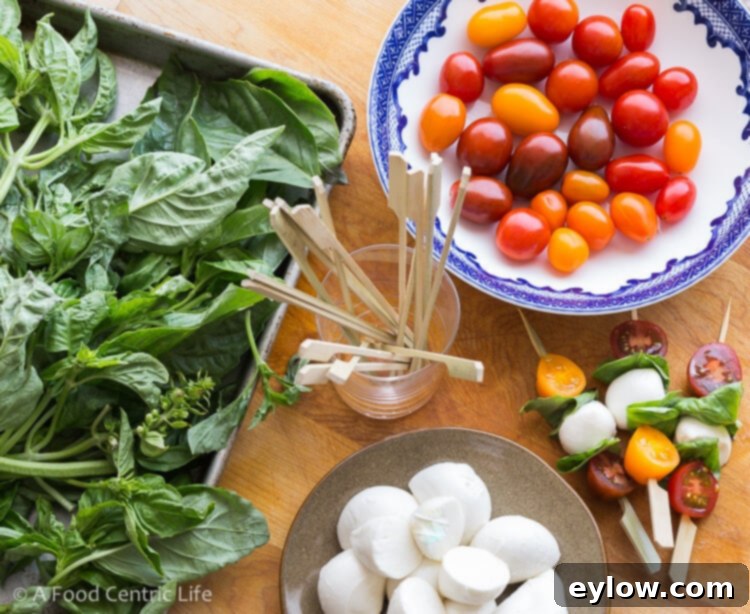 Quick Caprese Bites with Homemade Basil Vinaigrette 4 Assembling caprese skewers with basil, mozzarella, tomatoes, and mini skewers.