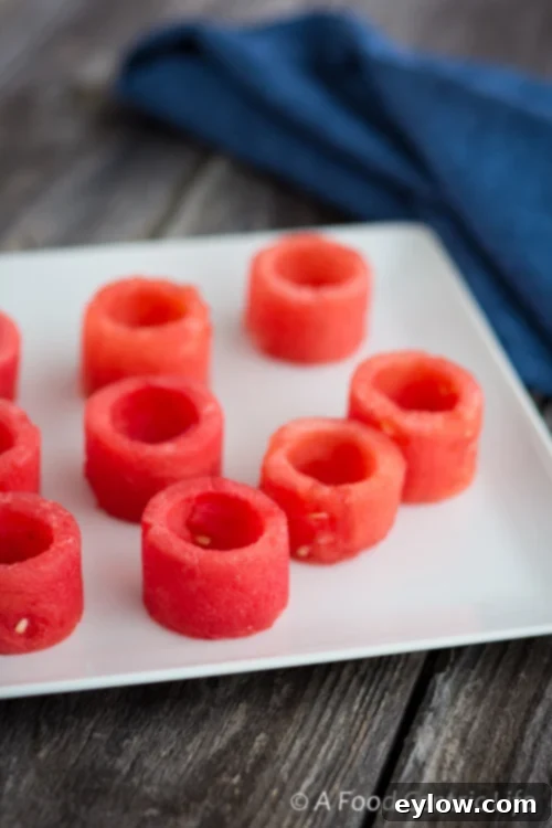 Summer Watermelon Goat Cheese Bites 3 Watermelon slices being prepared with a cookie cutter for appetizer cups