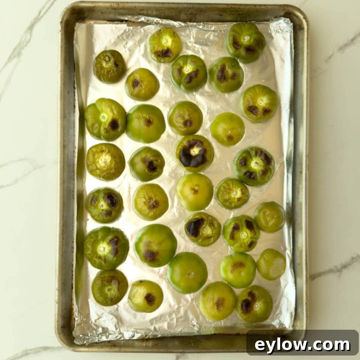 Green tomatillos after broiling with browned spots.