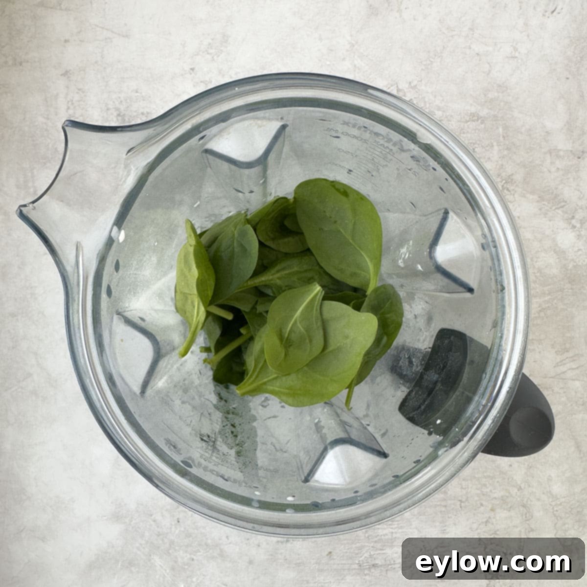 Revitalizing Green Detox Smoothie 4 Baby spinach leaves and other ingredients in a blender, ready for blending into a smoothie.