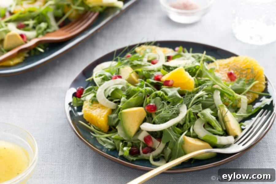 Irresistible Pomegranate Seed Dishes 6 Orange, avocado and fennel salad with pomegranate seeds on a light blue linen tablecloth.