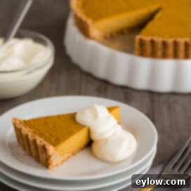 A whole gluten-free pumpkin tart, perfectly baked and ready for slicing.