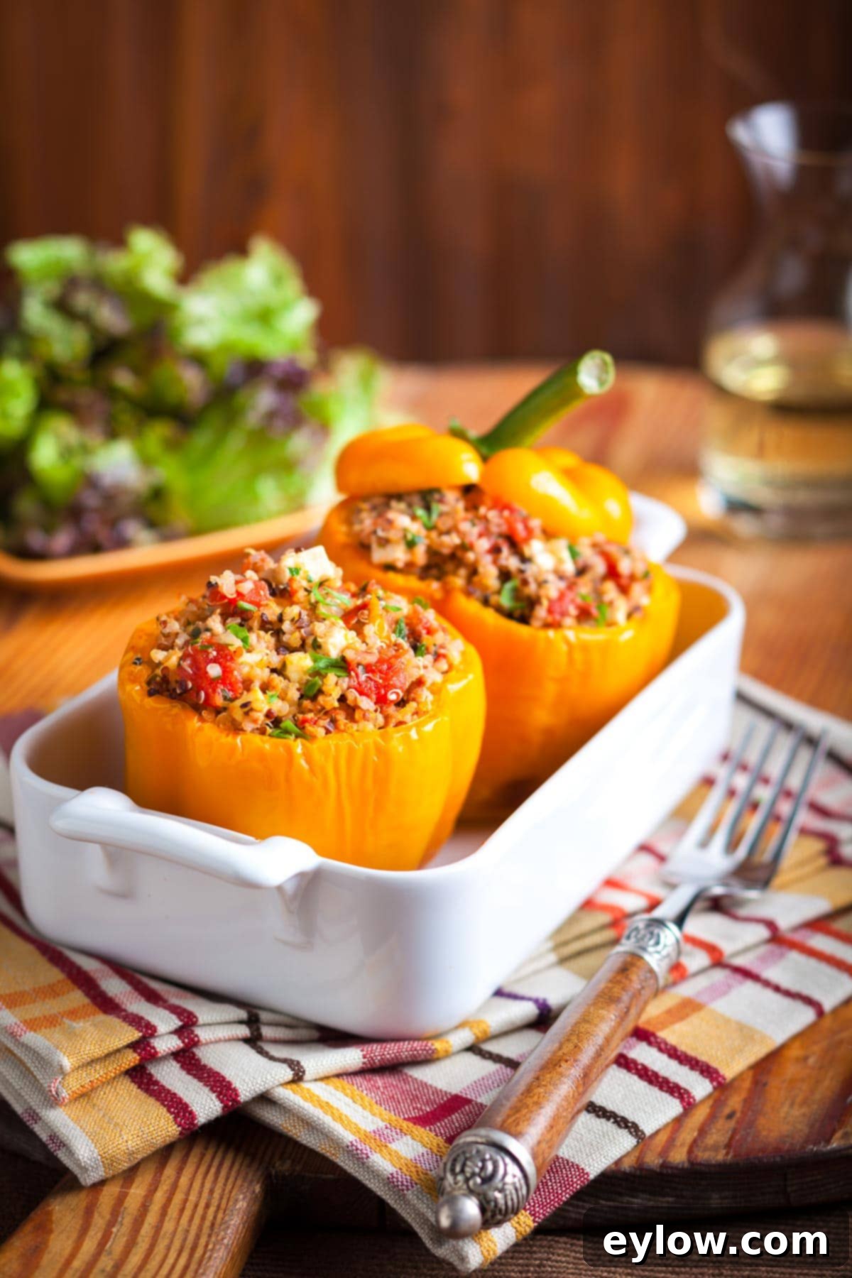 Flavorful Turkey Stuffed Pepper Boats 9 A white casserole dish filled with beautifully baked orange bell peppers generously stuffed with ground turkey and quinoa, ready for serving.