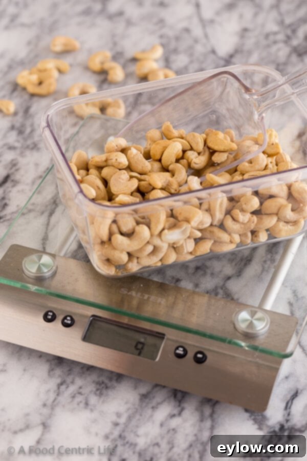 Creamy Homemade Cashew Milk 3 Weighing raw cashews on a kitchen scale to ensure accurate measurements for homemade cashew milk.