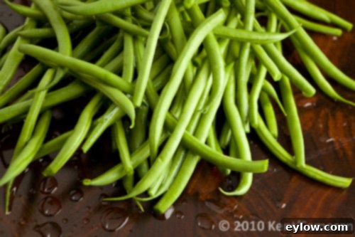Green Beans-7326 Raw green beans piled on a cutting board.