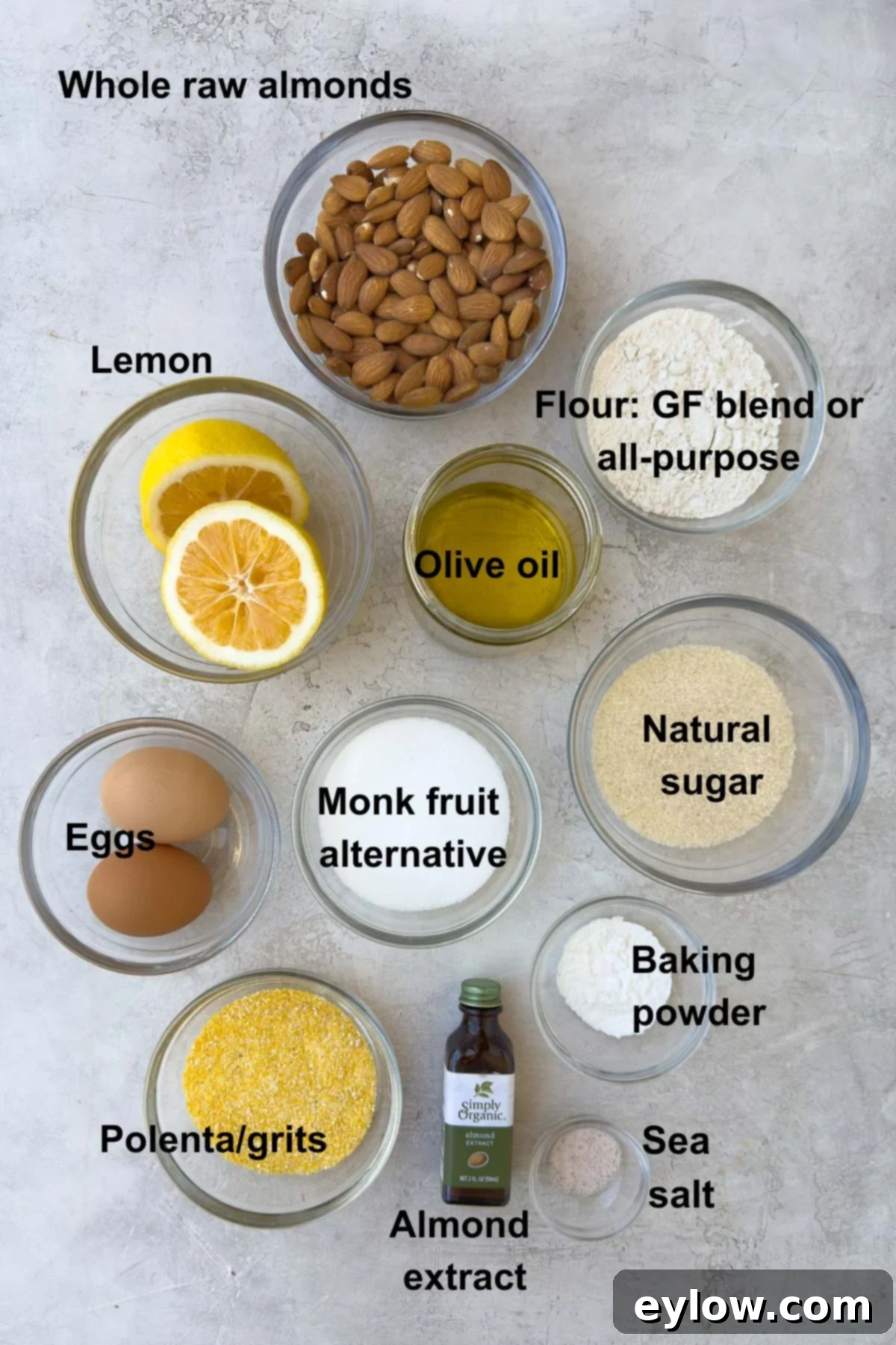 Ingredients for lemon olive oil cake in bowls on counter.