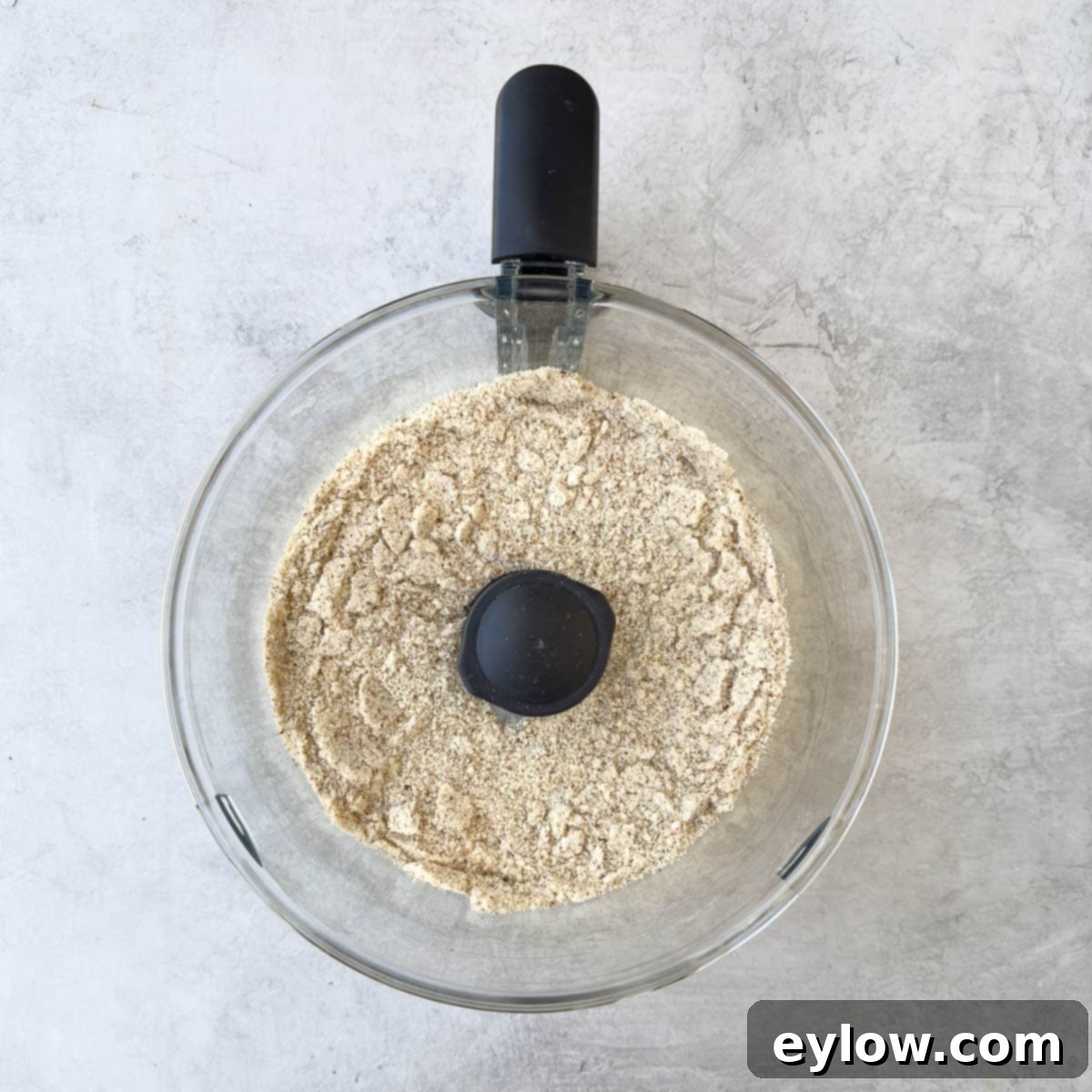 A sandy textured mix of ground almonds and sugar after processing.