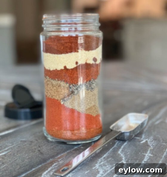 A glass jar of spices ready to be shaken to make a dry rub. 