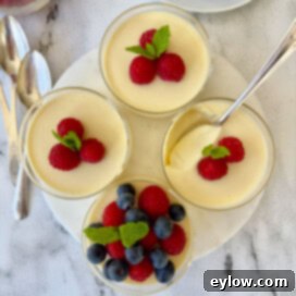 Simply Divine Lemon Posset 9 Four lemon posset custard dessert cups topped with fresh berries.