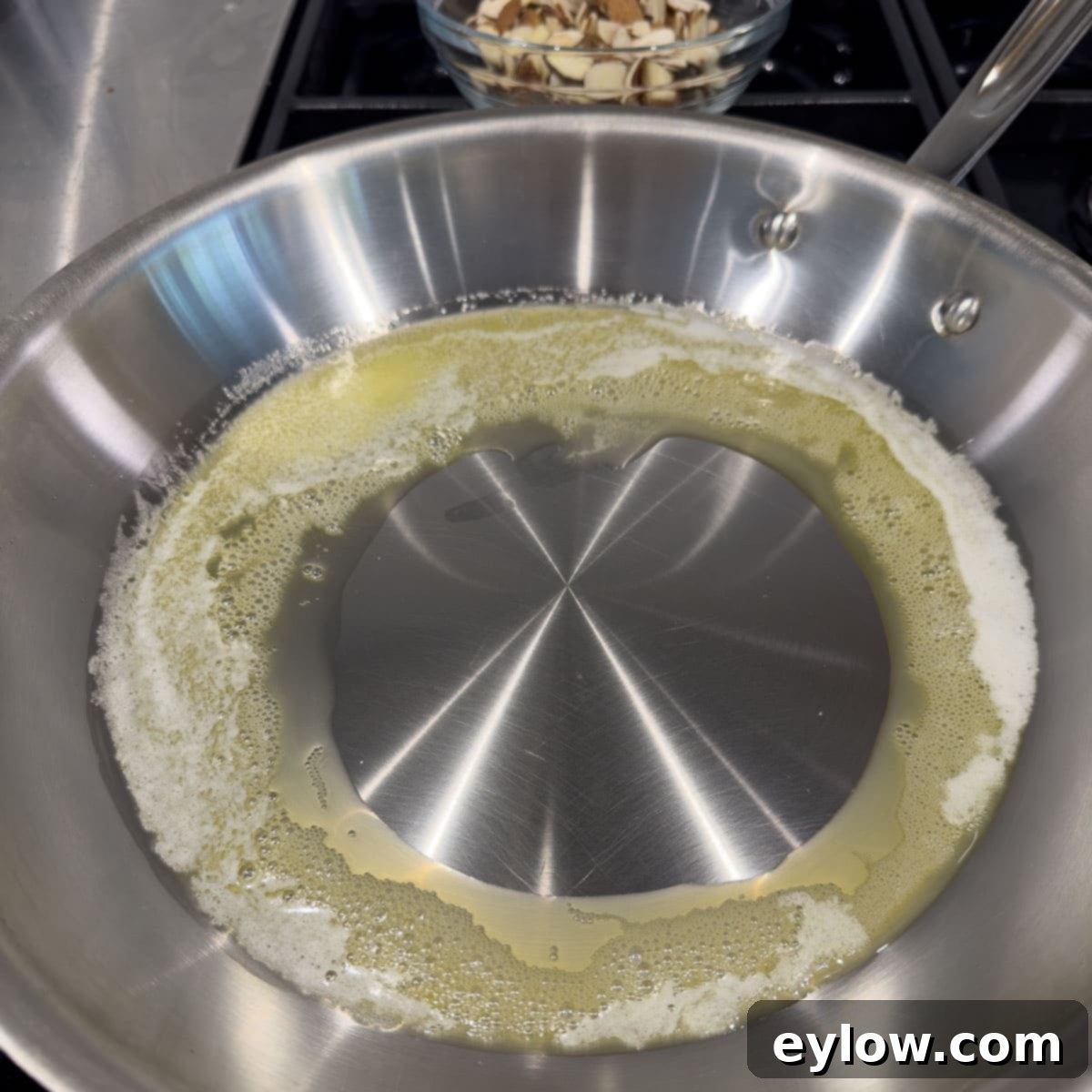 Melting butter in a stainless steel fry pan. 