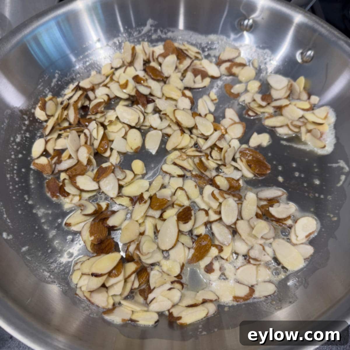 Starting to toast almonds in butter on the stove top.