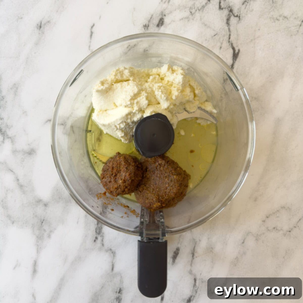 Velvety Sun-Dried Tomato Pesto Pasta 5 Food processor bowl with ricotta cheese, pesto, oil, and lemon juice ready to be pureed into a sauce.