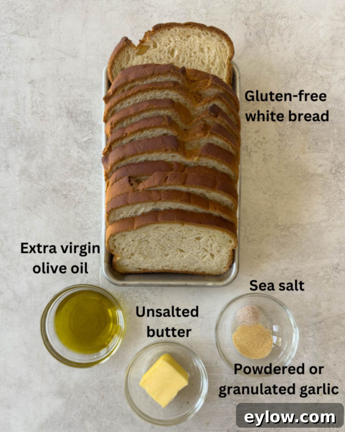 Ingredients to make homemade croutons, bread, olive oil, butter, salt, and garlic powder.