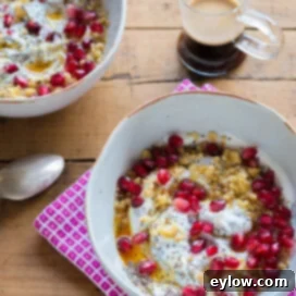 Greek yogurt breakfast bowl with pomegranate seeds, walnuts, and chia seeds for high protein.