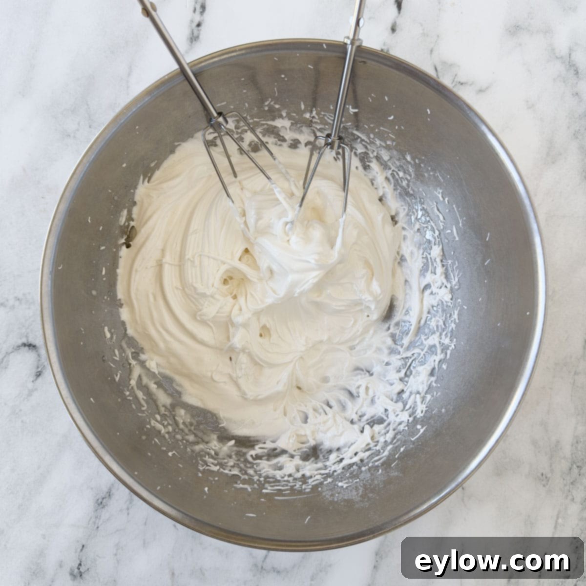 Egg whites for meringue whipped to stiff peaks, standing tall and firm, ready for the next step.