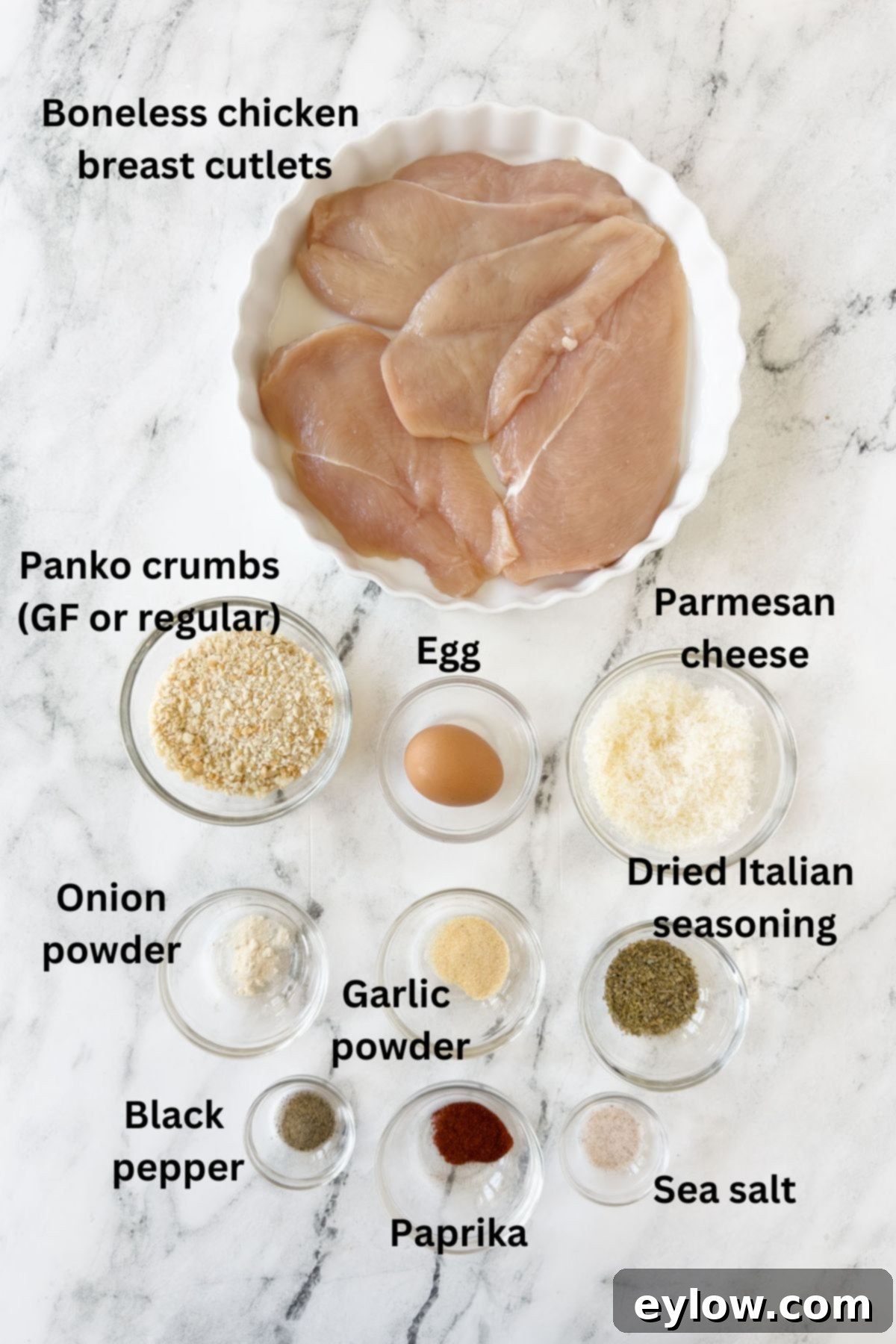 Ingredients for air fryer breast chicken cutlets in prep bowls on counter.