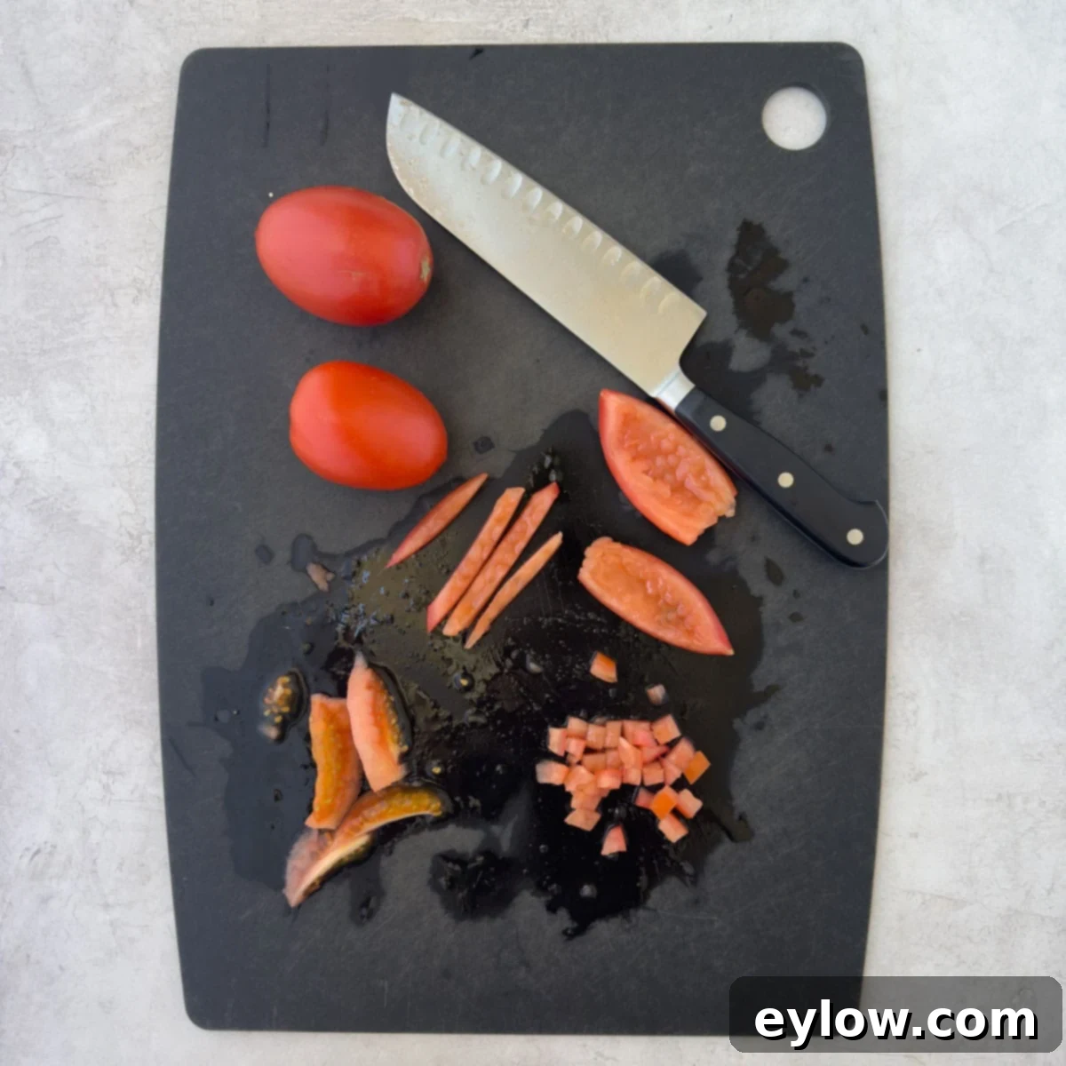 How to dice tomatoes, on a cutting board.