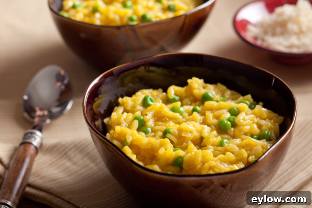Golden risotto Milanese with saffron and peas in a bowl served as a side dish.