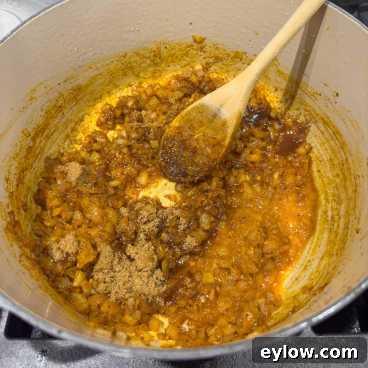 Sautéed golden onions with smoked paprika and brown sugar stirred in, creating a rich base.