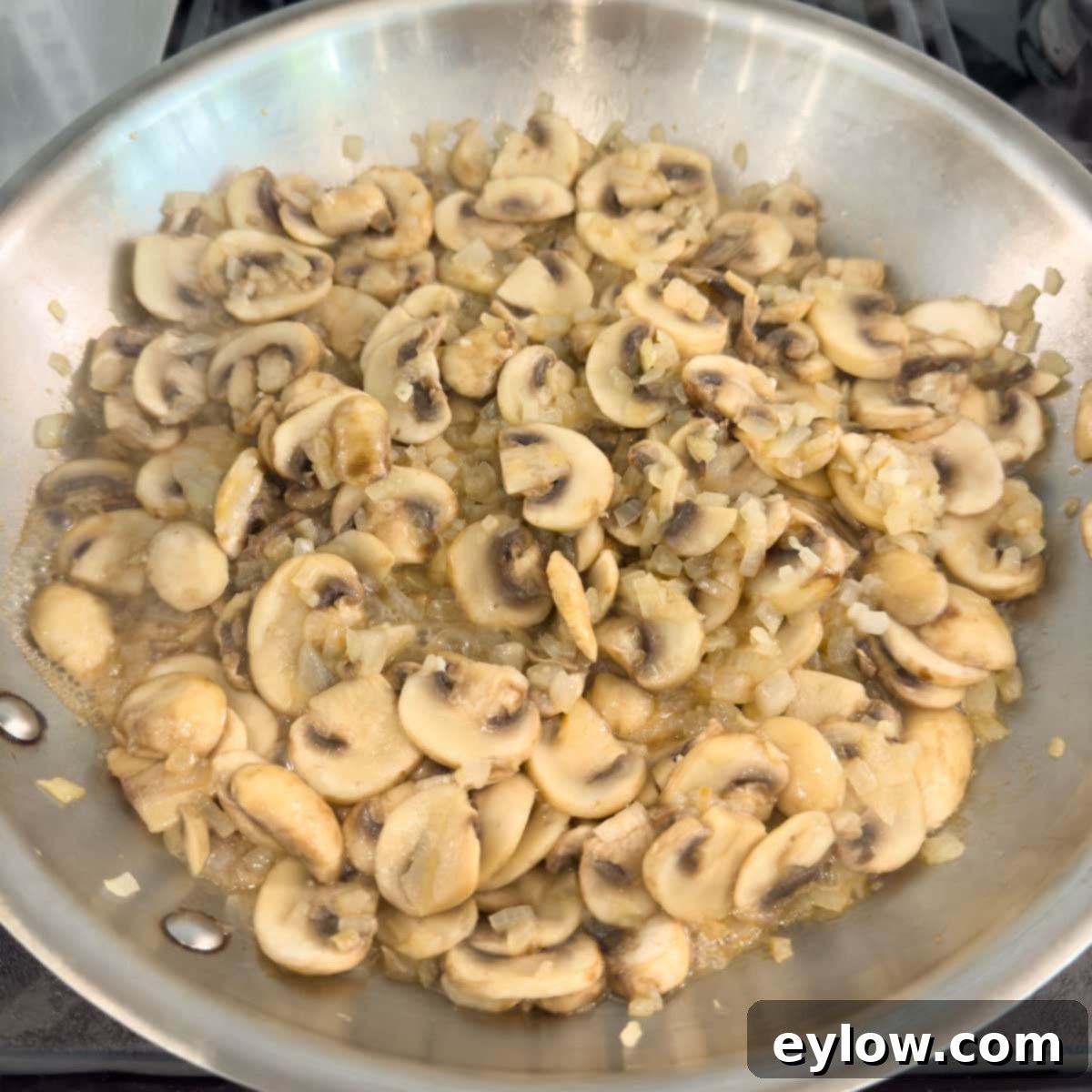 Sliced mushroom and onions cooked until tender and light brown.