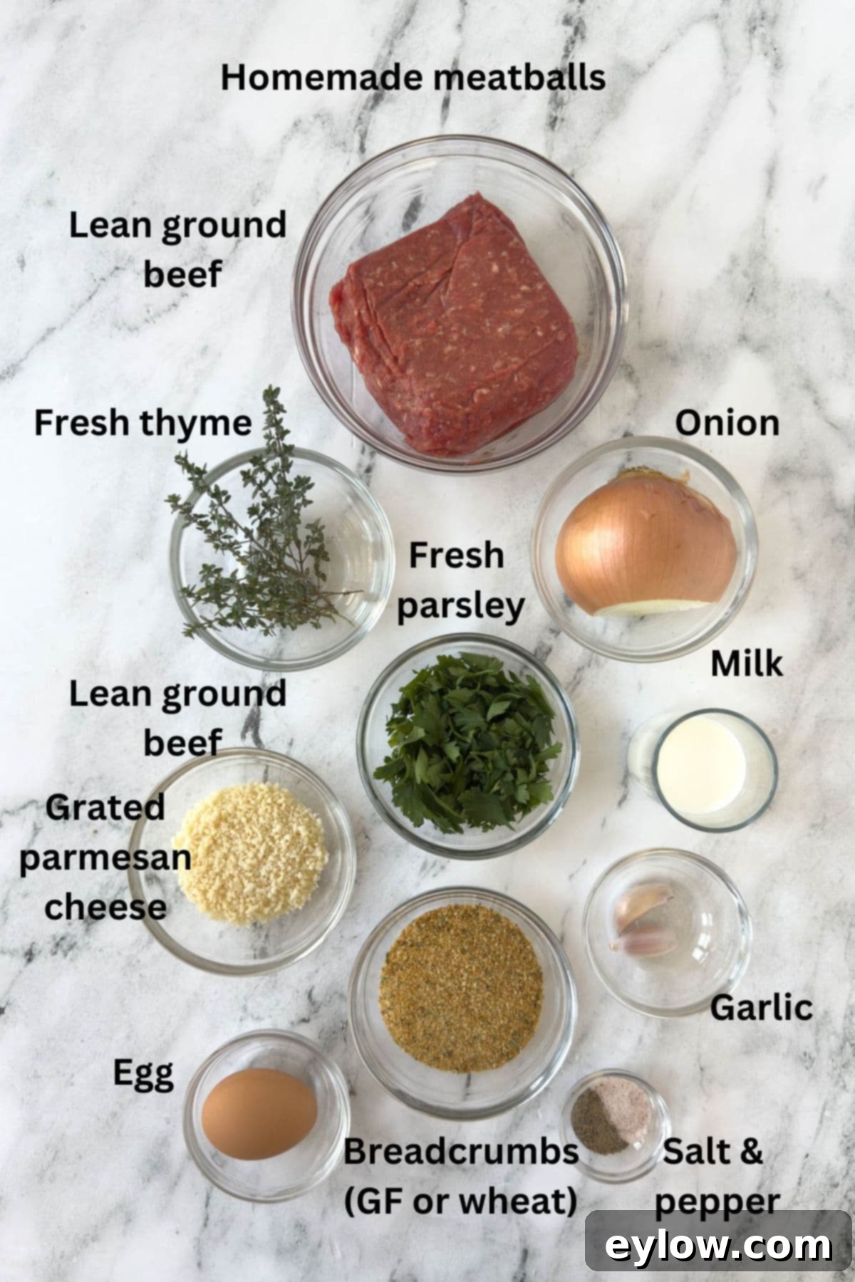 Ingredients for beef meatballs in prep bowls on the kitchen counter.