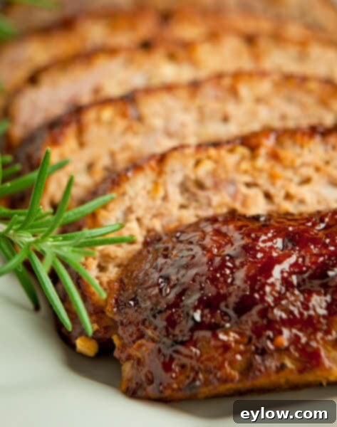 BBQ Glazed Gluten-Free Meatloaf 2 Delicious Barbecue Glazed Meatloaf on a white platter, ready to be served as a hearty family meal | AFoodCentricLife.com