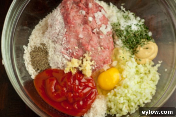 Meatloaf Ingredients Individual ingredients for Barbecue Glazed Meatloaf laid out: ground beef, onions, apples, and spices | AFoodCentricLife.com
