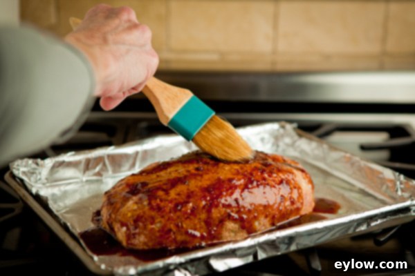Meatloaf Brushing Sauce Brushing the barbecue glaze generously onto the shaped meatloaf on a baking sheet before it goes into the oven | AFoodCentricLife.com