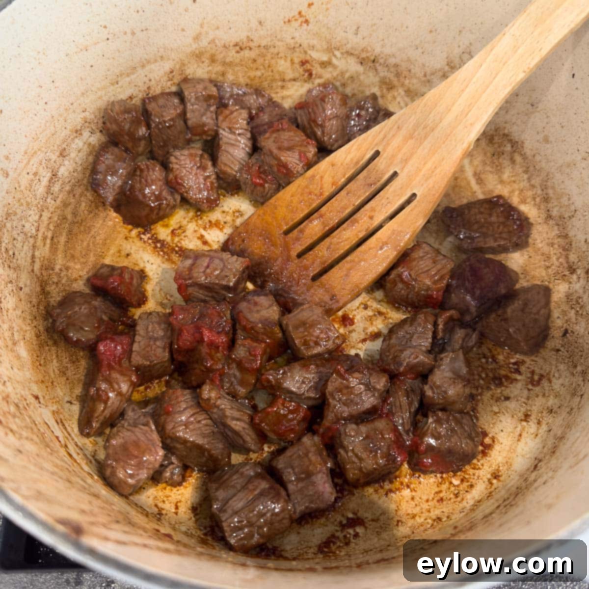 Hearty Beef, Barley & Vegetable Soup 6 Adding tomato paste to browned meat in a Dutch oven for caramelization and flavor.