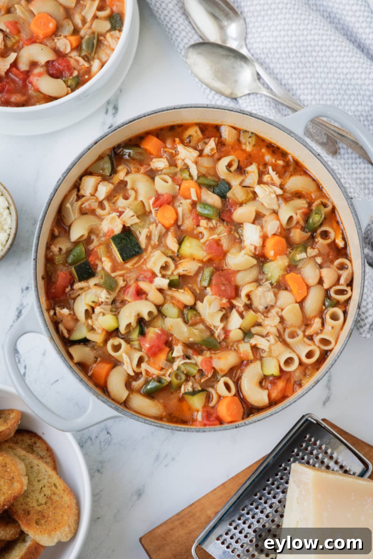 Soul-Warming Chicken Minestrone 2 A large pot of colorful chicken minestrone with toasts and parmesan. soup