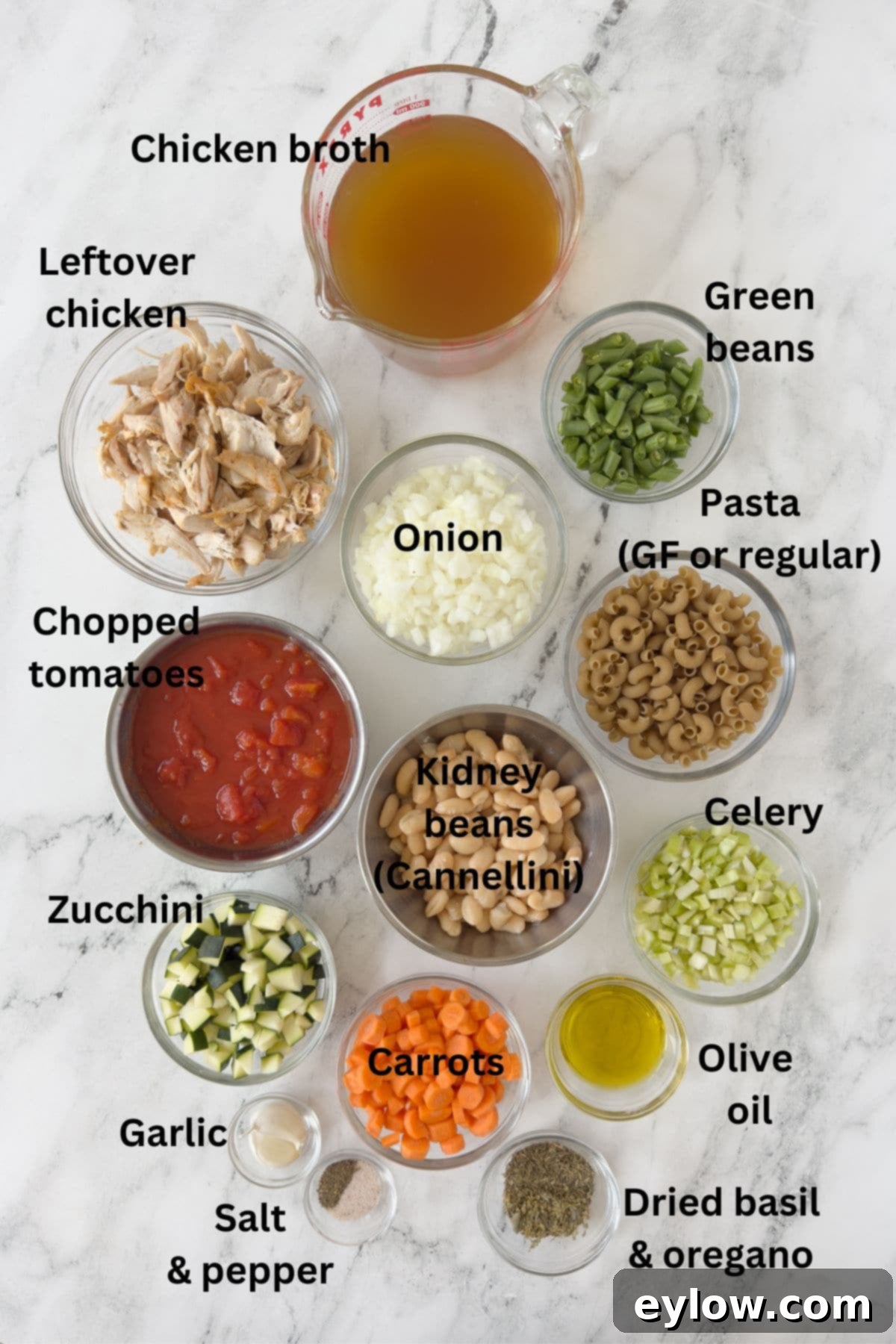 Soul-Warming Chicken Minestrone 3 Ingredients for chicken minestrone soup in prep bowls on a marble counter.