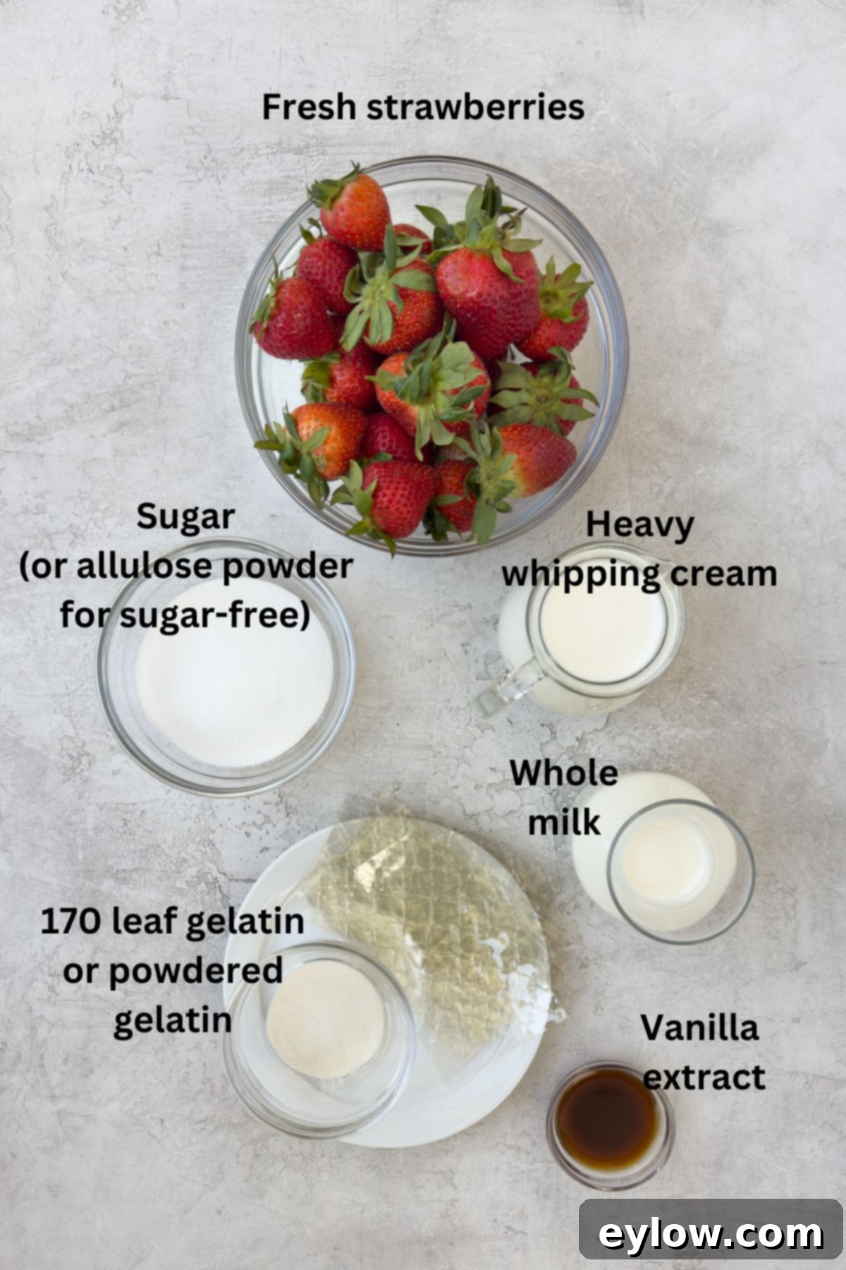 Velvety Strawberry Panna Cotta with Sweet Berry Drizzle 3 Ingredients for strawberry panna cotta in prep bowls on a gray counter.