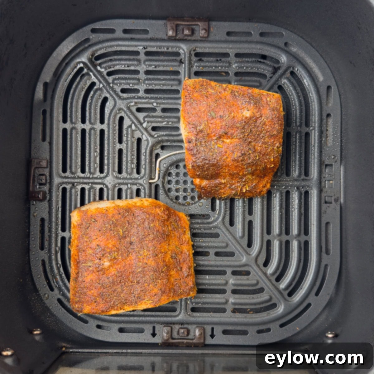 Crispy Blackened Mahi Mahi in the Air Fryer 7 Air fryer mahi mahi with a blackening seasoning in the air fryer basket.