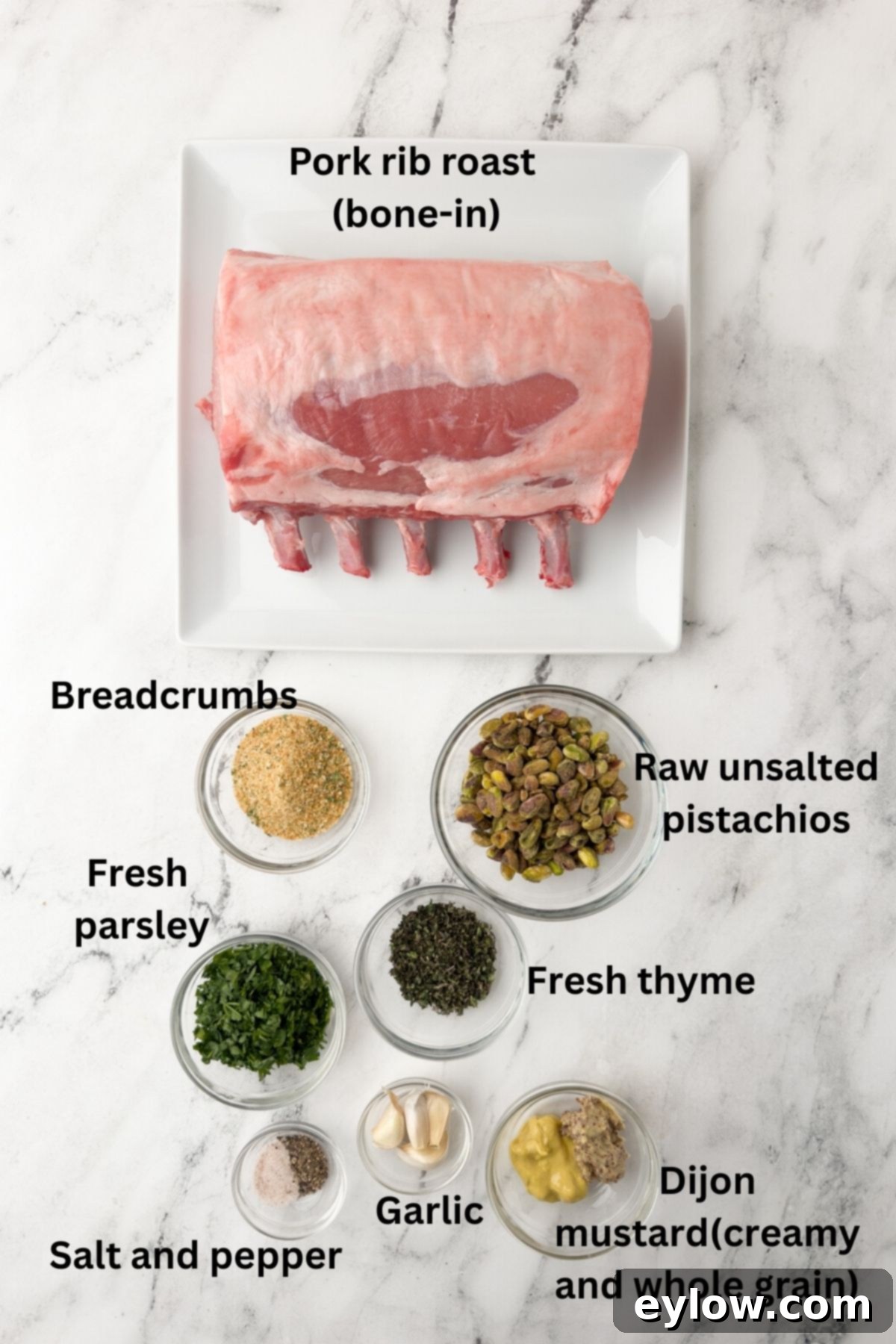 Pistachio-Encrusted Pork Rib Roast 3 Ingredients for bone-in pork rib roast on a marble counter.