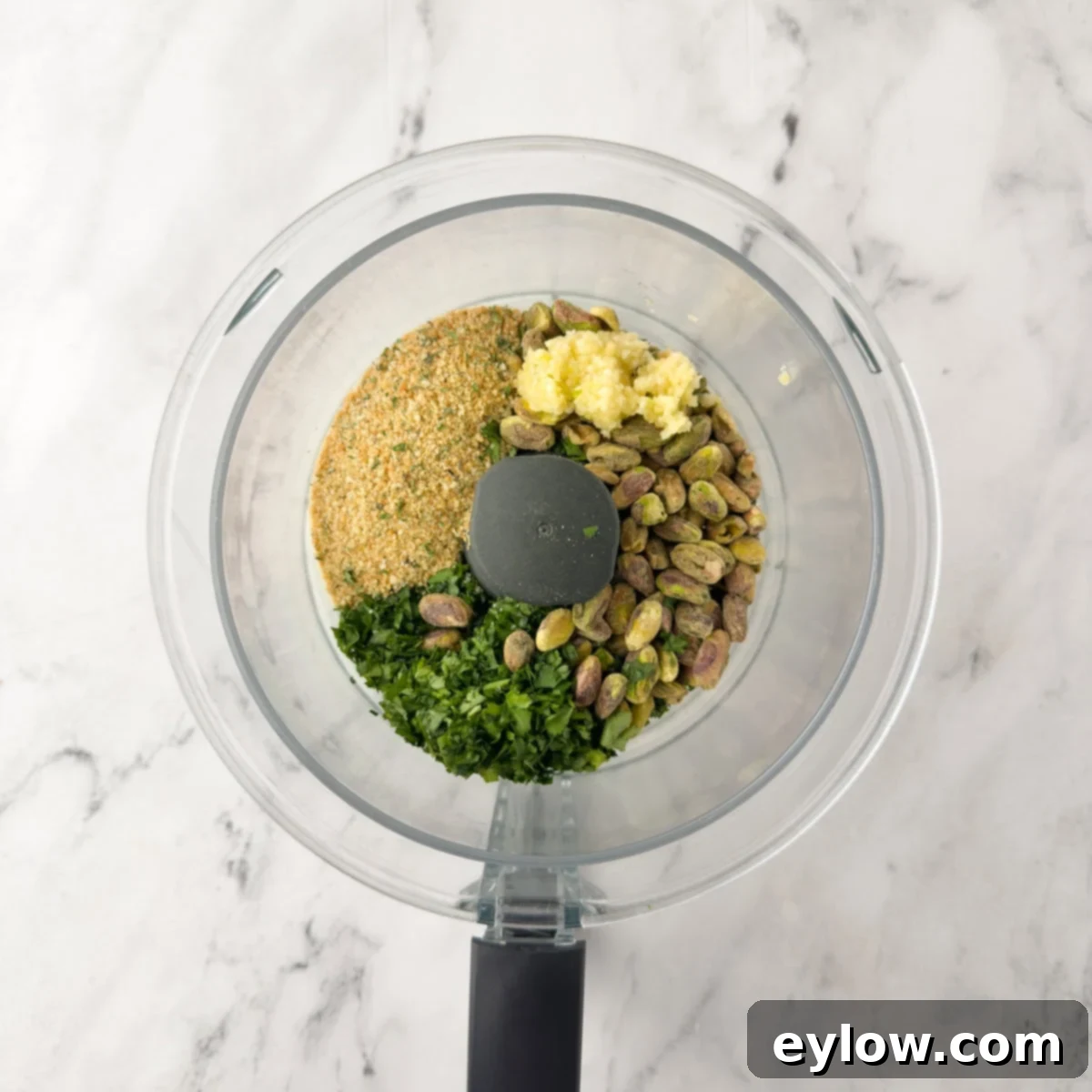 Pistachio-Encrusted Pork Rib Roast 4 Ingredients for pistachio crust in a food processor work bowl.