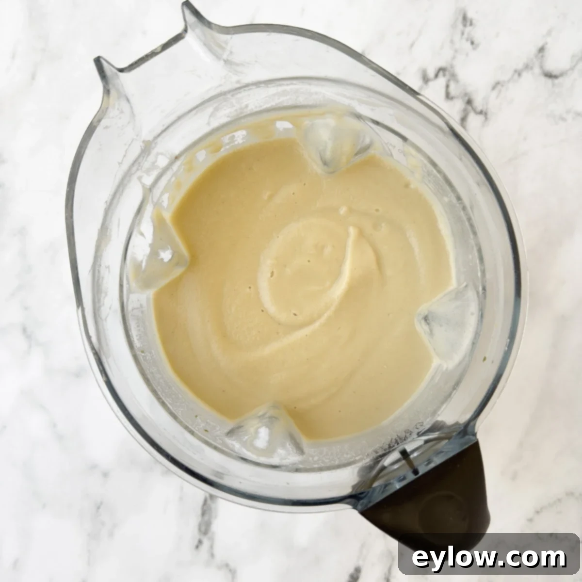 Velvety Fennel and White Bean Soup 5 Blender container full of pureed pale colored creamy fennel soup.